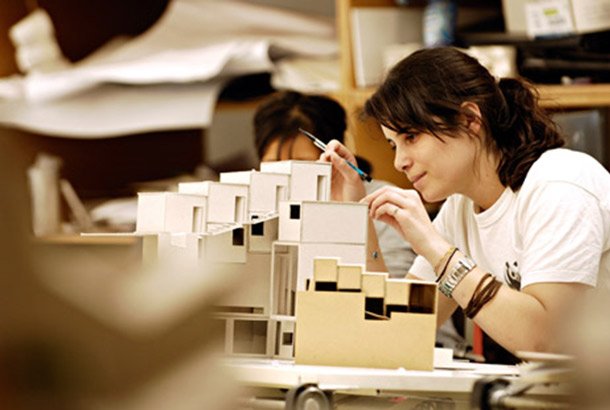 postgraduate architecture student creating a conceptual model in a research-based lab environment, highlighting the advanced, specialized nature of m.arch education.
