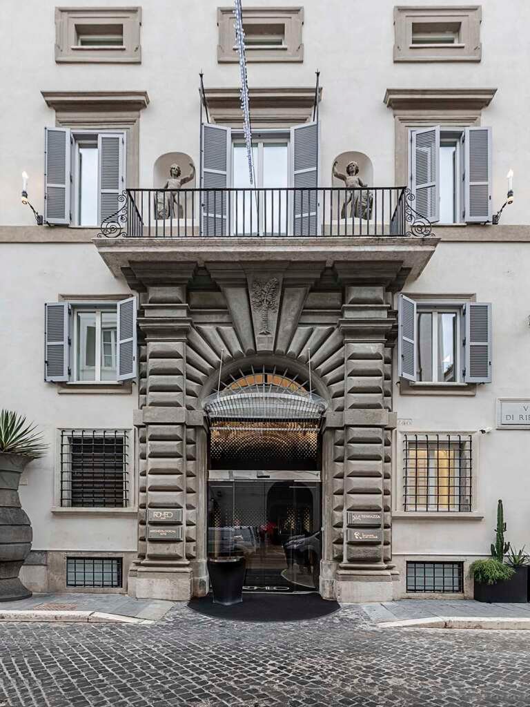 historic façade of the 16th-century palazzo capponi, now transformed into hotel romeo roma designed by zaha hadid architects