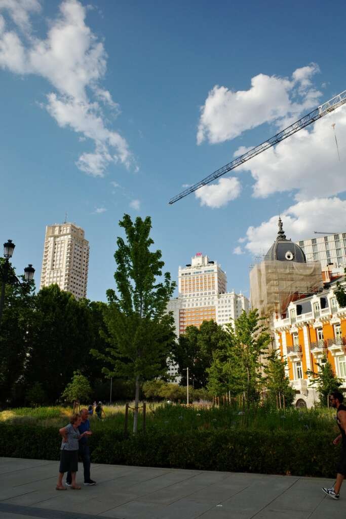 Architectural Photography: Revealing What Drawings Can’t 2 neighbourhood of buildings with people strolling around