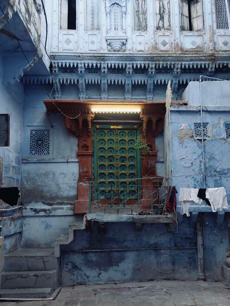 Architectural Photography: Revealing What Drawings Can’t 3 haveli painted in blue with a wooden main door and weathered finish
