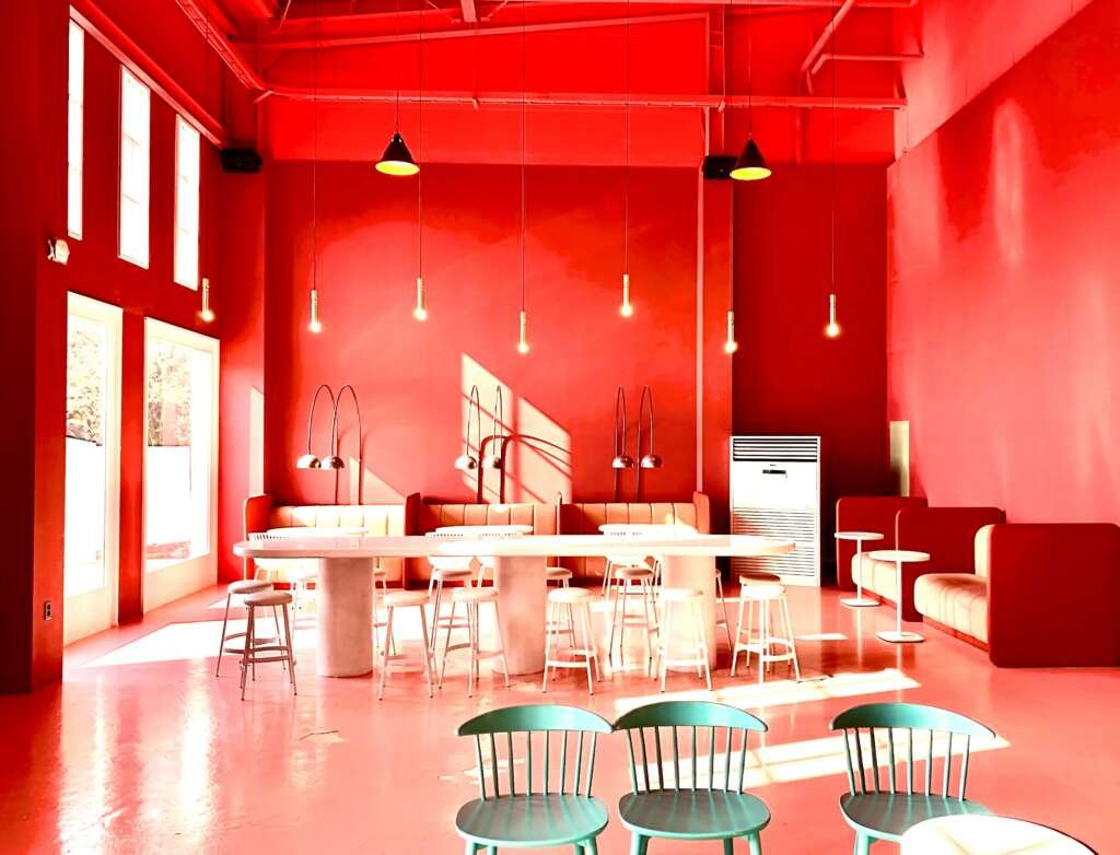a restaurant with red walls, a bar and dining