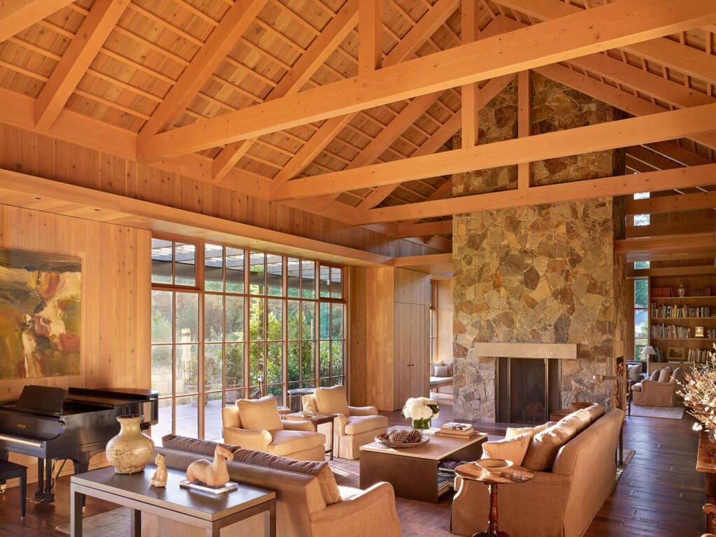 a biophilic living room with abundant natural light, indoor plants, and natural materials like wood and stone, creating a harmonious connection with nature
