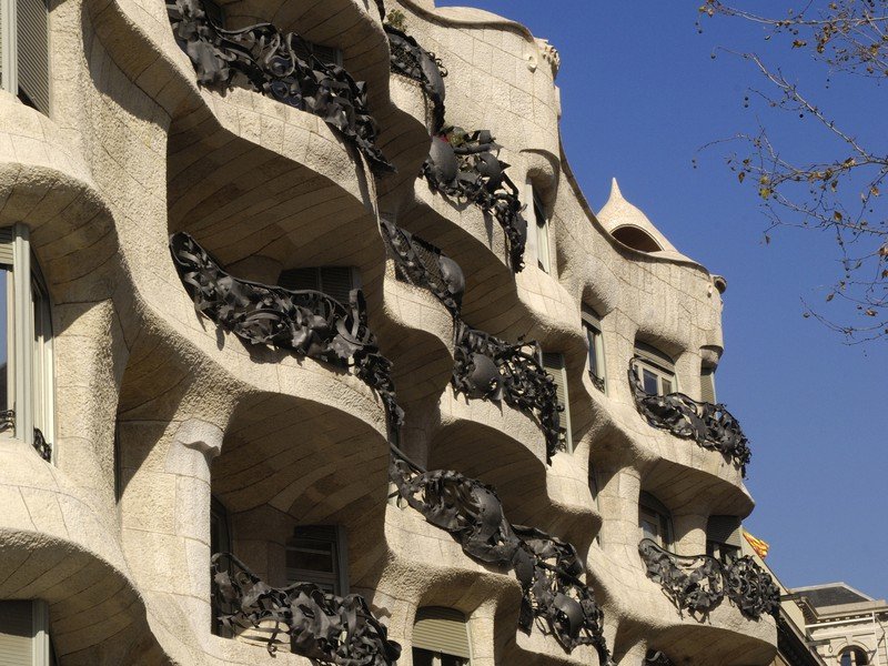 casa milà's iconic undulating façade with wavy stonework and curving balconies