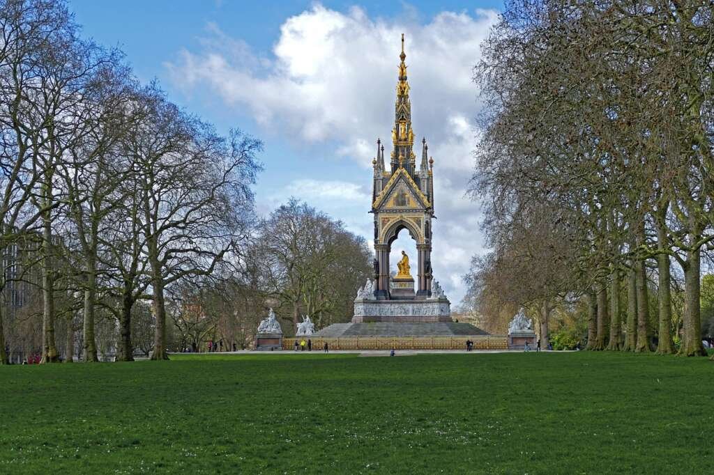 a wide, green expanse in central london with walking paths, trees, and people enjoying the open space in the heart of the city.