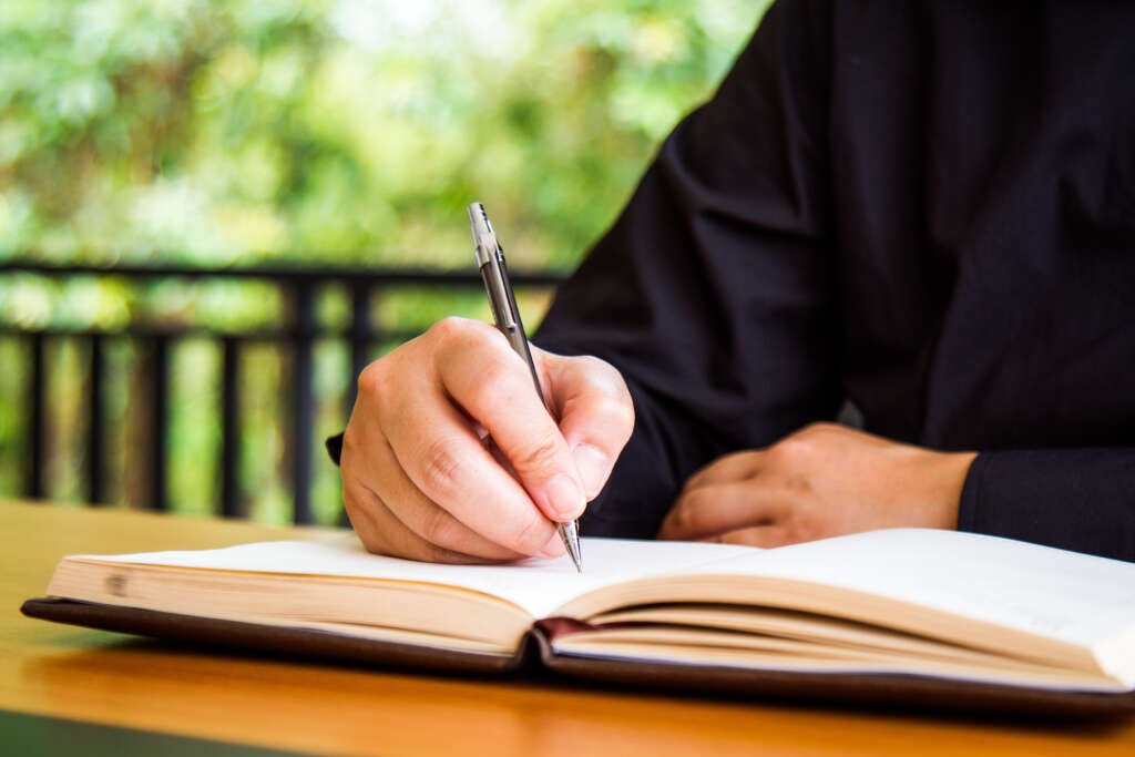 businessman write a book on workplace with copy space.